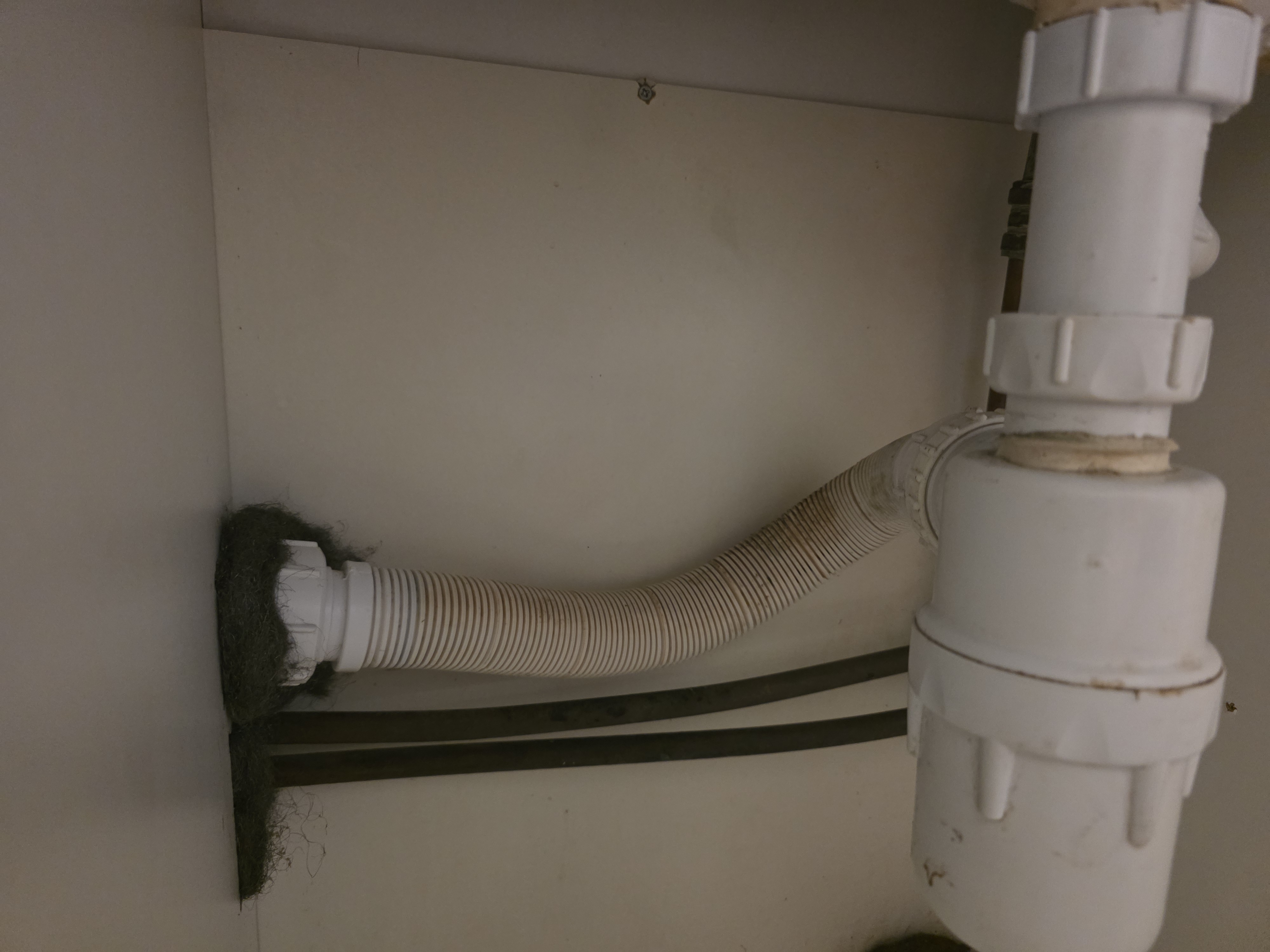 Poor quality waste pipework under a kitchen sink