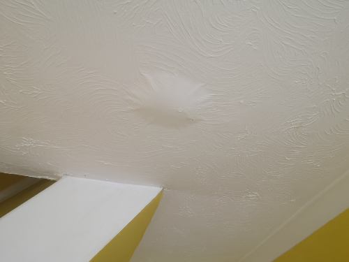 Water stain on a ceiling below a leak