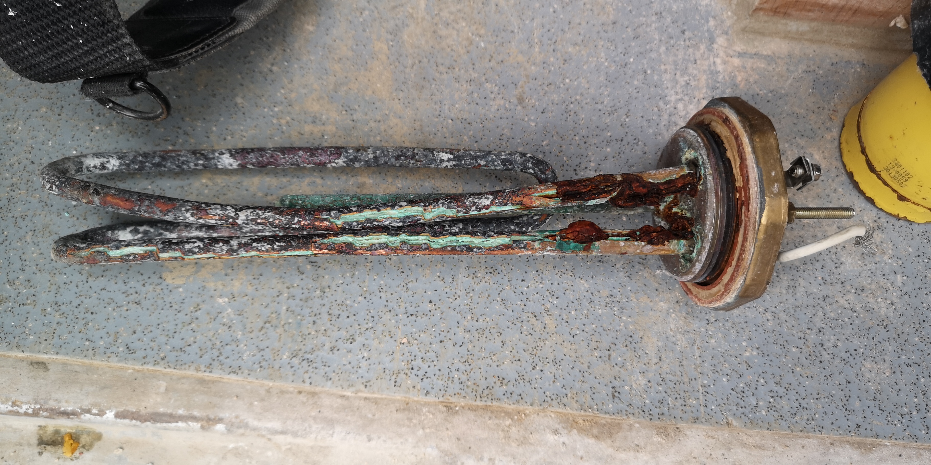 Scaled and leaking immersion heater removed from a cylinder