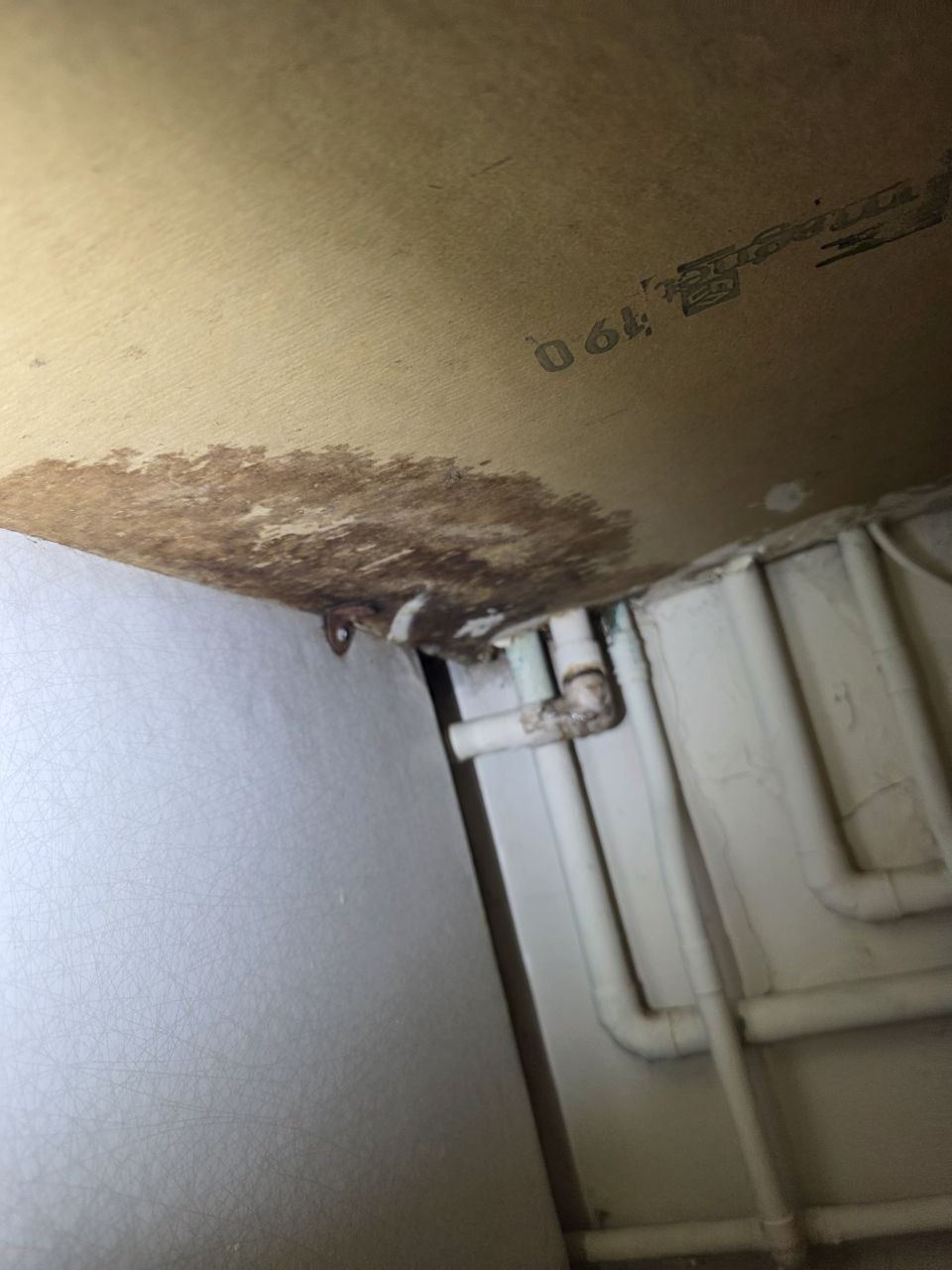 Water damage to the underside of a kitchen worktop
